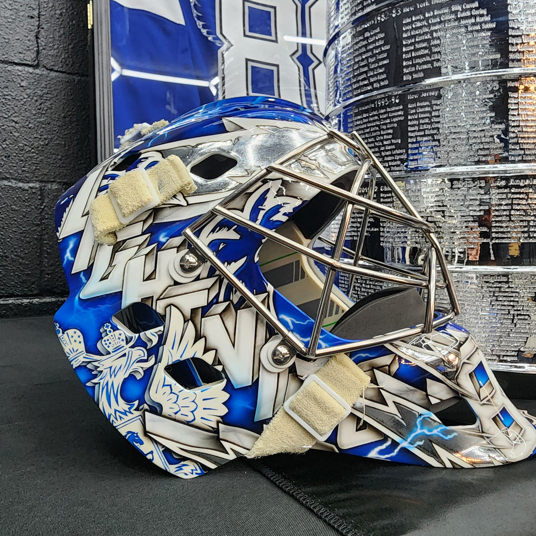Featuring: Andrei Vasilevskiy Goalie Mask Game Worn 2022-23 Tampa Bay Lightning Sylabrush Painted on Bauer Shell - 2nd Half of Season + Playoffs Photomatched